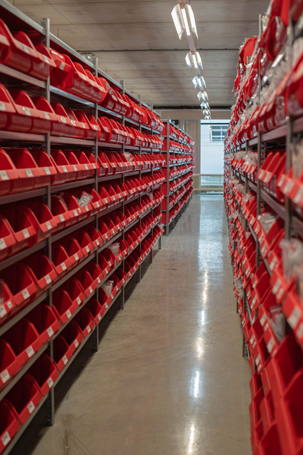 Warehouse racking and storage bins.